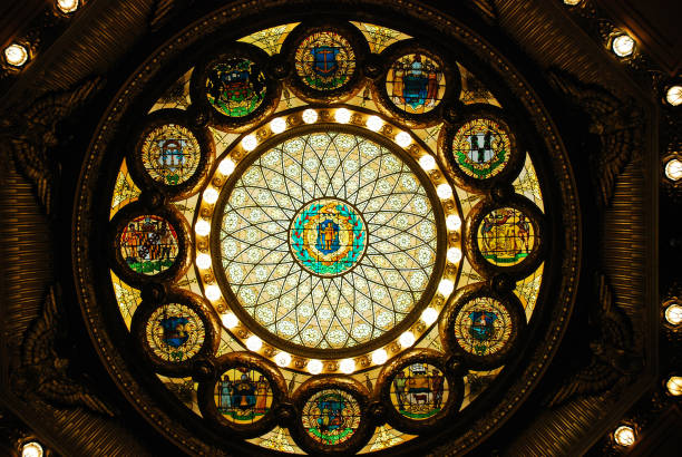 The abstract lights and ceiling wainscotting within the historic Faneuil hall in boston Massachusetts.
