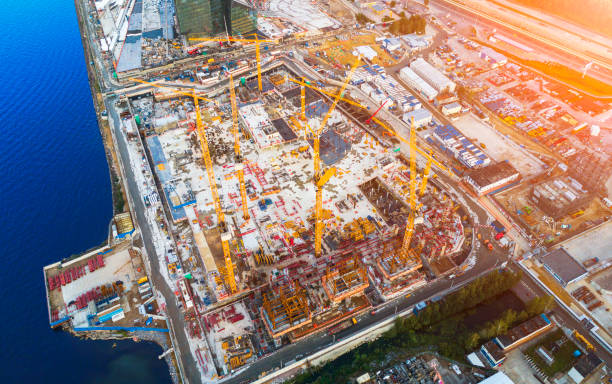 istock Aerial view of a Construction crane tower. Top view Crane and building working progress. Worker. Construction Site view by drone. Aerial top view a New buildings with a crane. Tower crane 1088745314