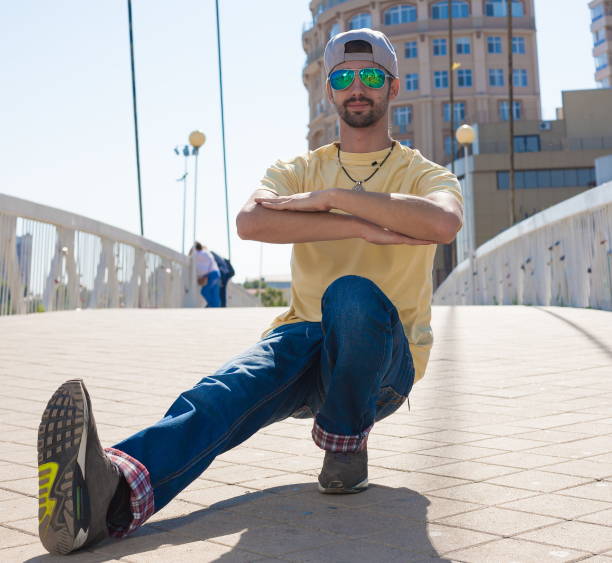 istock Man dancing yellow shirt blue jeans sunglasses 1088755950