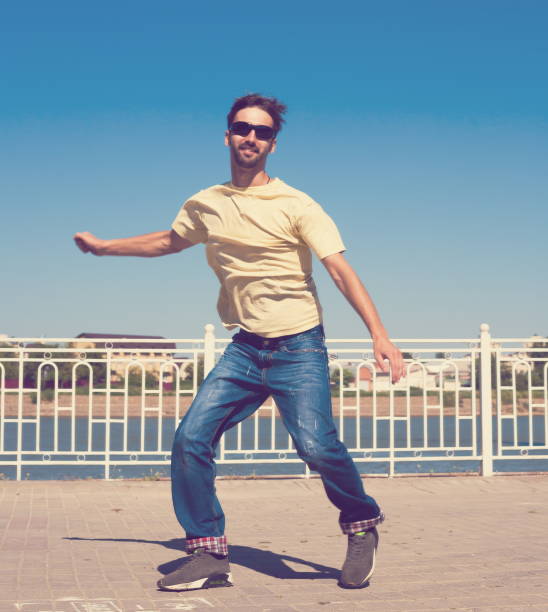 istock Man dancing yellow shirt blue jeans, jump 1088756132