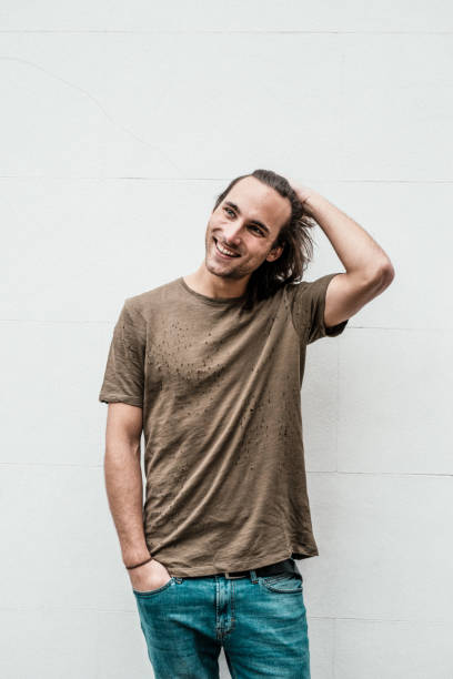 istock Cheerful guy posing in short sleeves near the wall 1088756230
