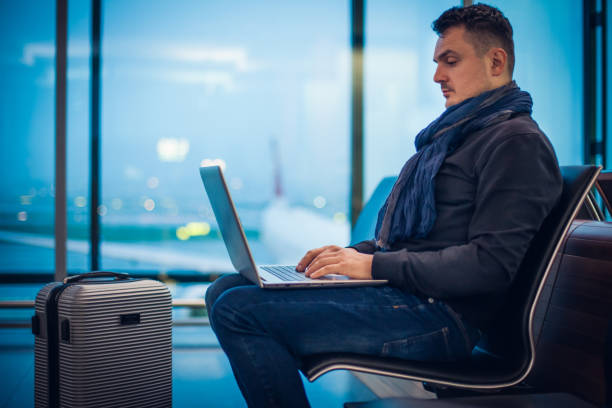 istock Male Passenger Using Laptop Computer at the Airport 1088763158