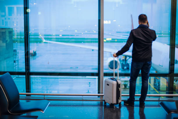 istock Man Talking on Cell Phone at the Airport 1088763184