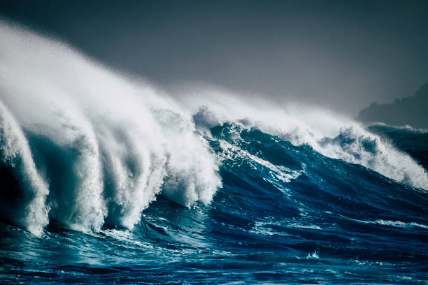 dangerous powerful energy wave big splash white foam and blue deep water - oceanic storm and bad weather climate change for world disease for temperature changed - surfer break point - tide sea breaking water imagens e fotografias de stock