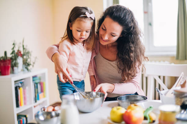 istock Happy mother and daughter in kitchen 1088779984