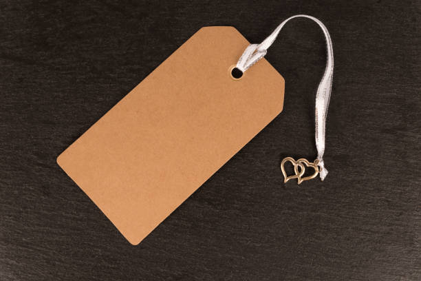 istock Natural blank old paper, cloth tag or label, isolated on a dark slate. 1088783982