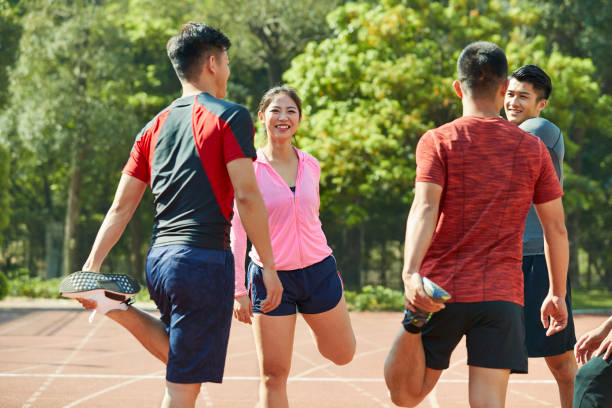 istock young asian athletes stretching arms and legs 1088785788
