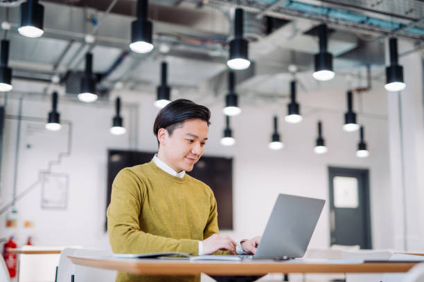 istock Taiwanese businessman working on laptop in modern office 1088786098