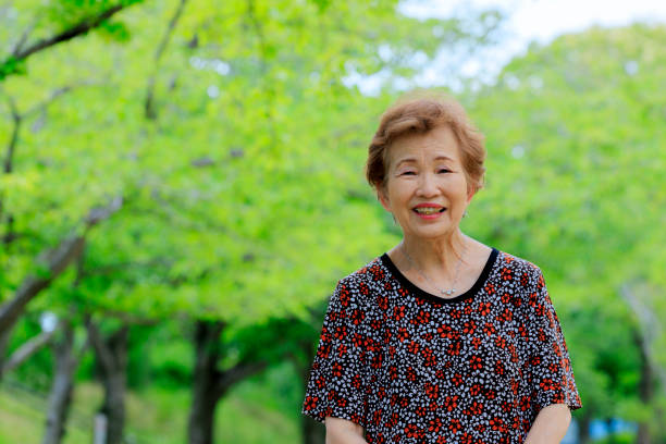 istock Elderly women with green background 1088792980