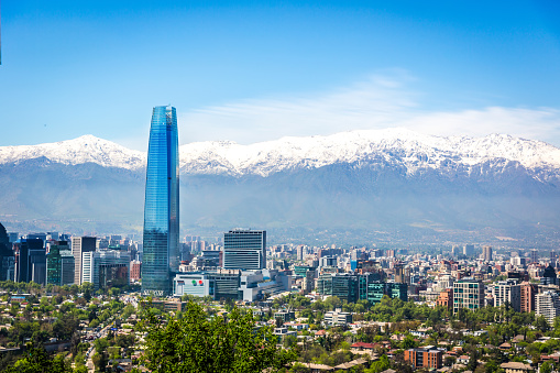 Amazing aerial view of Santiago city with the Andes range covered in snow in the background in Chile