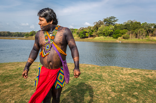 Embera Drua Villiage, Panama - Mar 3rd 2018 - An indigenous man dressing with his traditional clothes and paints in the edge of a river at Embera Drua Villiage in Panama