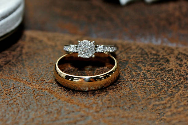 istock Gold and Diamond Wedding Ring on Leather Surface 1088813382