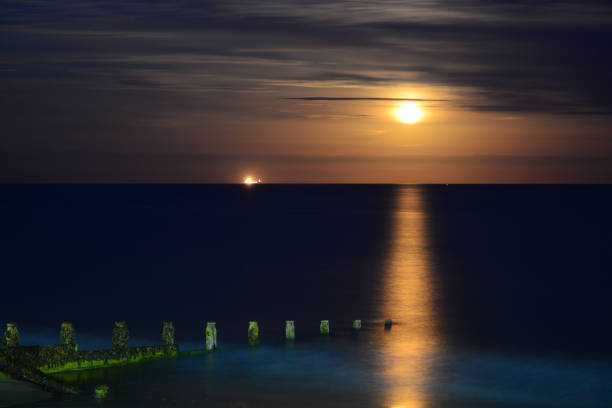 istock Moon Rise Over Bay and Breakwater 1088813580