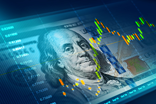 US dollar and euro banknotes over digital screen with real life exchange chart, USD EUR parity concept