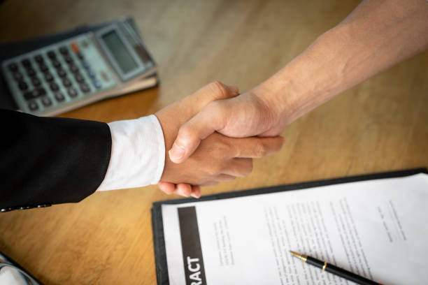 istock Banker business man shaking hands with client and sign contrac document for comfirm corporation or finished loan agreement for house or building property.Document in photo is fake only for stock phoot. 1088815852