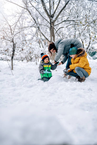 istock Mother helping son putting on snow gloves 1088816444