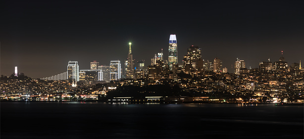 Iconic San Francisco view of the skyline at night with all of the city lights glowing. All of the iconic buildings downtown pictured. Travel/Tourism. Large file