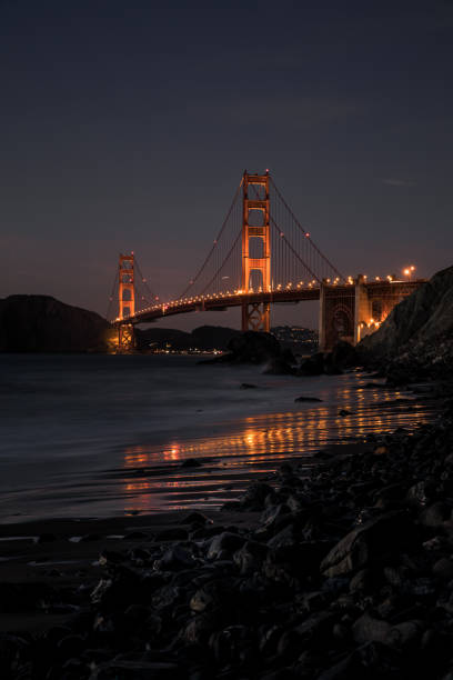 istock Golden Gate Bridge night with reflection in sand on the beach in San Francisco 1088817902