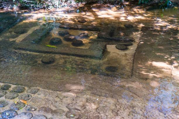 istock stone carving in the river at Kbal Spean 1088825548