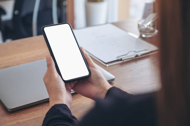 istock Mockup image of hands holding black mobile phone with blank white screen 1088835018