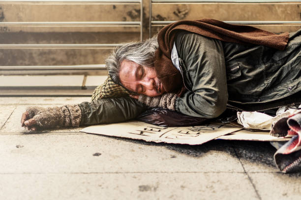 istock Poor homeless beggar laying and sleeping on pathway 1088835360