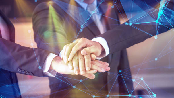istock businessmen stack hands together in concept of business network unity 1088835488
