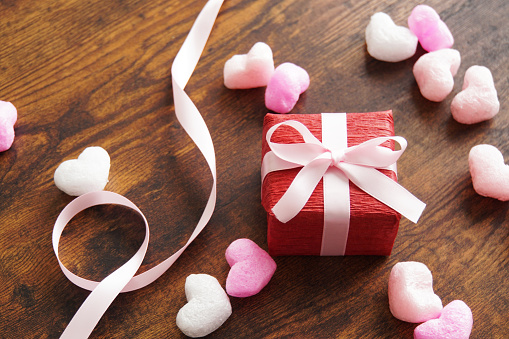 Mother’s Day and Valentine’s Day concept with red and white tulips and heart shaped gift box