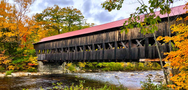 istock Red covered bridge during New England fall foliage season 1088842286