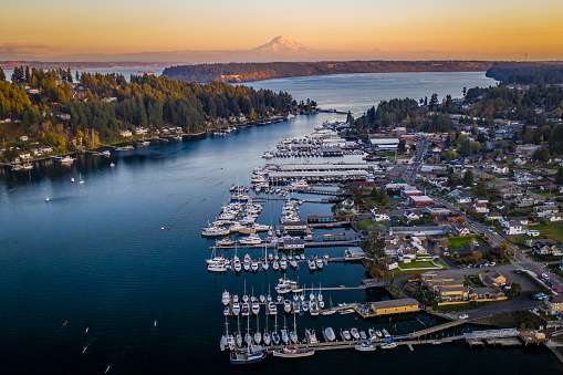 A drone view of boats in Gig Harbor Washington at sunset with Mt Rainier