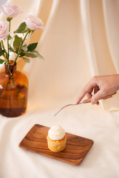 istock Female hands cut the delicious cupcakes on table 1088860128