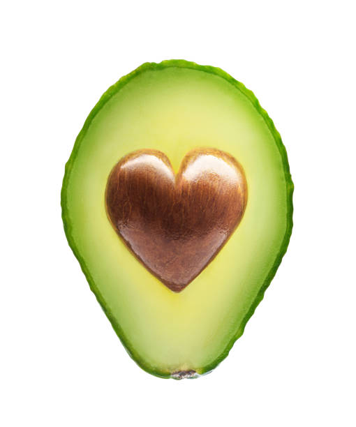 Avocado with heart shape seed Avocado with heart shape seed isolated on a white background avocado brown stock pictures, royalty-free photos & images