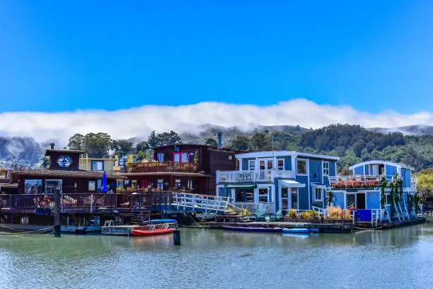 Colorful house boats floating on water on a sunny day in Sausalito, San Francisco bay, USA