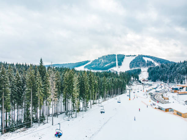 istock BUKOVEL, UKRAINE - December 9, 2018 - people skiing and snowboarding down by hill. winter activity 1088868842