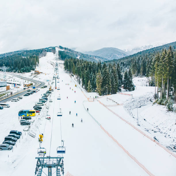 istock BUKOVEL, UKRAINE - December 9, 2018 - people skiing and snowboarding down by hill. winter activity 1088868852