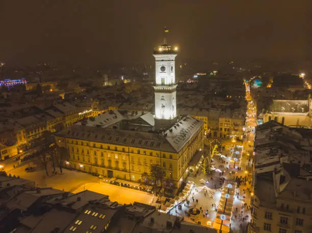 Photo of aerial view of capital building in center of european city at sunset in winter time