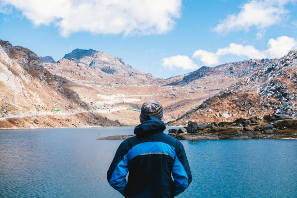 istock Man enjoying very much to look at blue lake 1088871914