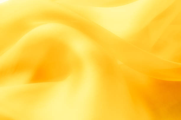 istock The photo is blurred. Texture, background, pattern. Yellow silk fabric. Abstract background of luxury blue fabric or liquid wave or wavy grunge texture. The whole background. 1088872026