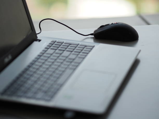 istock closeup one Notebook and mouse on the desk working 1088875408