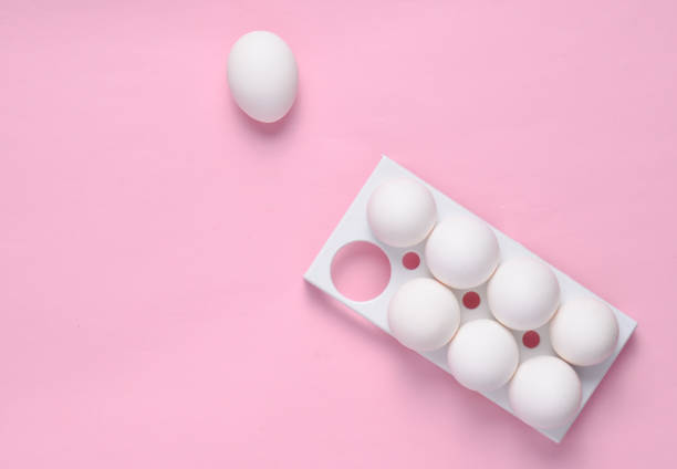 istock Plastic tray with white eggs on a pink pastel background, minimalism trend, top view 1088876208