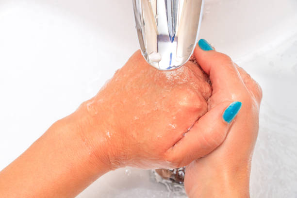 istock Female hands under running water in the sink 1088880564