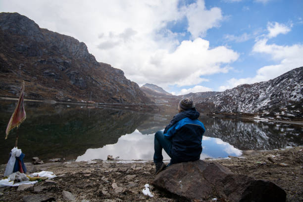 istock Man enjoying very much to look at blue lake 1088886050
