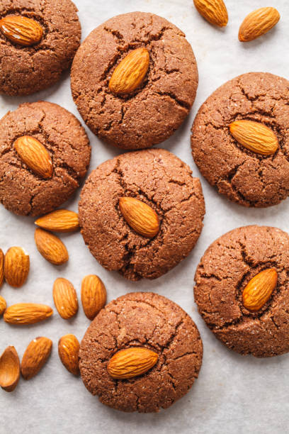 istock Chocolate cookies with almonds on white background, top view. Vegan dessert concept. 1088886190