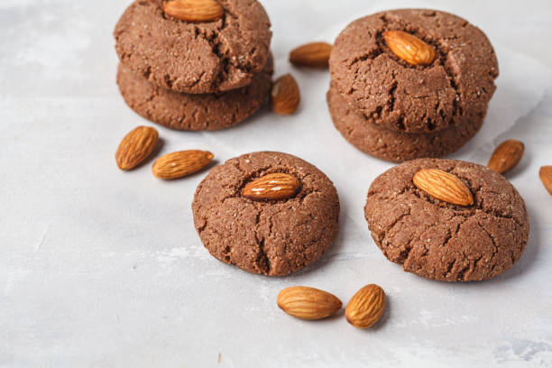 istock Chocolate cookies with almonds on white background, copy space. Vegan dessert concept. 1088886356