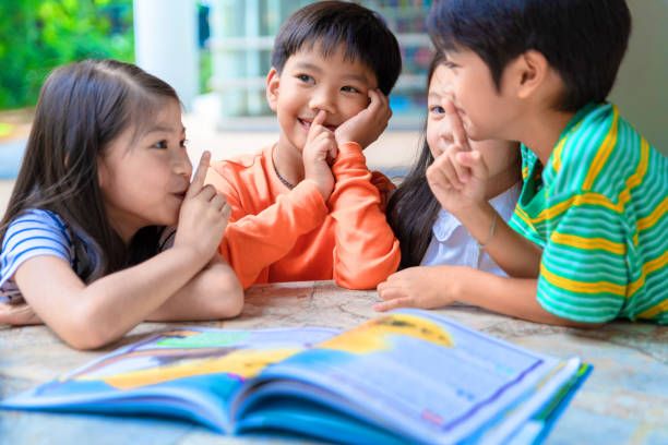 istock Asian Little Children Reading Book Cheerful 1088886942