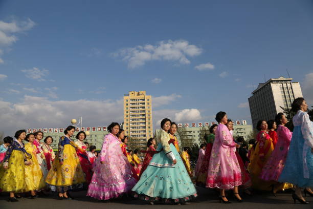 Pyongyang, North Korea - April 15, 2018.\nThere are big dance performances at different points of the city at the ceremonial ceremony of the founding leader Kim Il-Sung on April 15th.\nWomen in local dress returning from the birthday celebrations of North Korea's founding leader Kim Il-Sung.