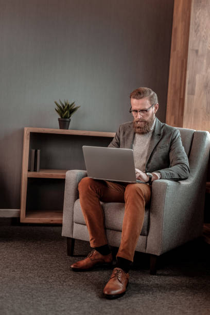 istock Attentive bearded man typing message to his partner 1088891106