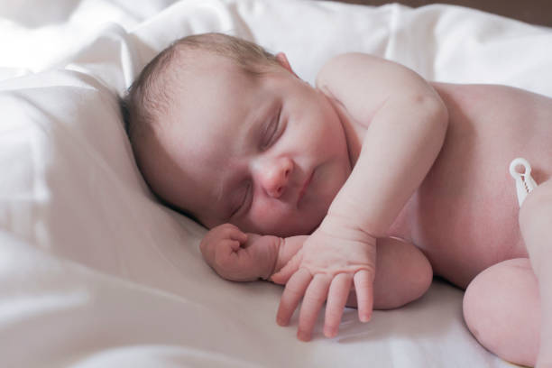 istock Newborn Baby girl sleeping in bed 1088898036
