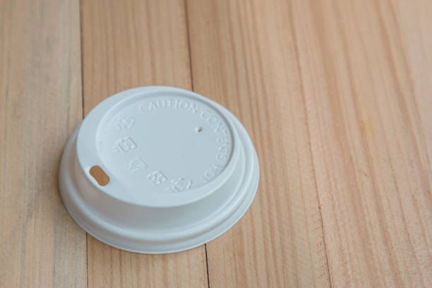 istock White cover coffee cup, Caution: contents hot, disposable plastic cover protect the hot coffee on wooden background 1088906104