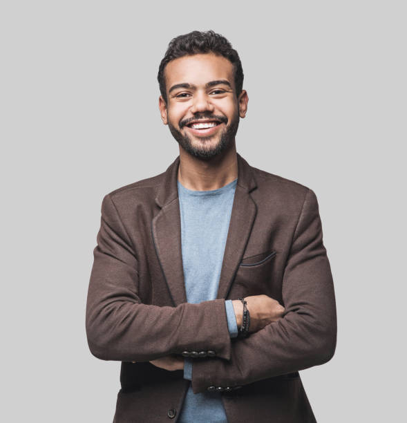 Portrait of handsome smiling young man studio shot Cheerful young men looking to the camera. Isolated on gray background one young man only photos stock pictures, royalty-free photos & images