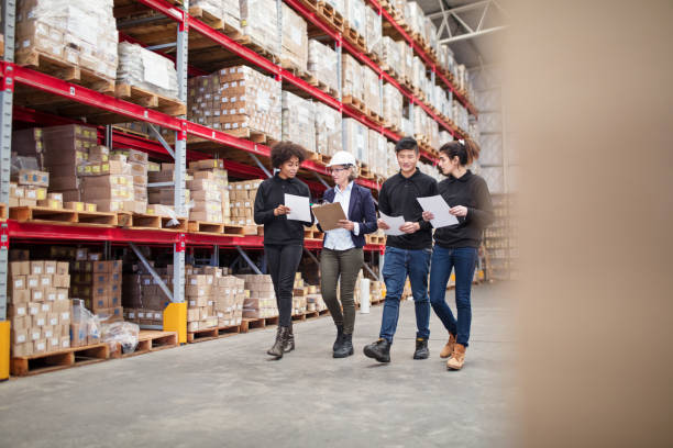 istock Warehouse employees walking by storage racks with product lists 1088912344
